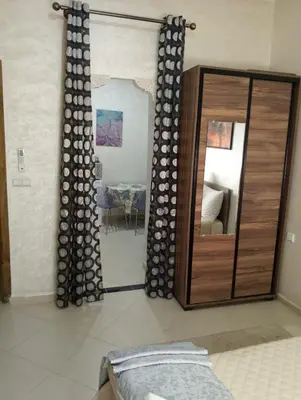 a bedroom with a mirror and a bed in a room at TheHive Residence in Fès