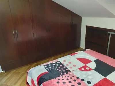 a bedroom with a bed with a colorful quilt on it at Dar diafa 2 in Imouzzer Kandar