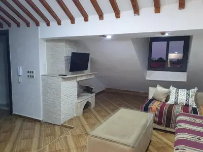 a living room with a couch and a tv at Dar diafa 2 in Imouzzer Kandar