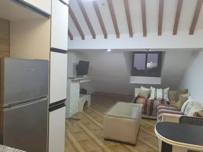 a living room with a couch and a table at Dar diafa 2 in Imouzzer Kandar