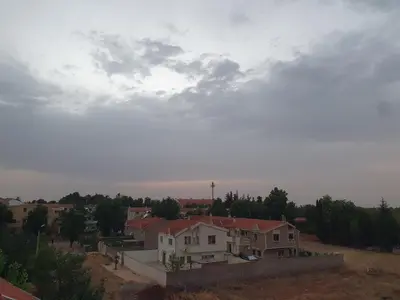 a group of houses under a cloudy sky at Dar diafa 2 in Imouzzer Kandar
