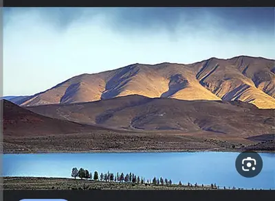 a view of a mountain with a body of water at auberge arhal lac tislit in Bou Tarhbalout