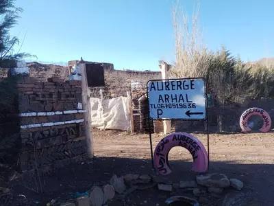 a sign for an entrance to an animal practition at auberge arhal lac tislit in Bou Tarhbalout
