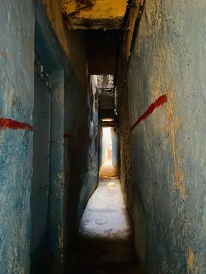 an alley way in an old building with a tunnel at Fes Antique Hostel in Fès