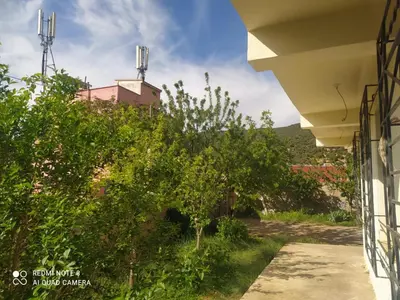 a view from the side of a building with trees at Dar khalid in Imouzzer Kandar