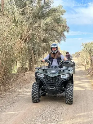 two people riding atvs down a dirt road at Sahara Desert Activites in Merzouga