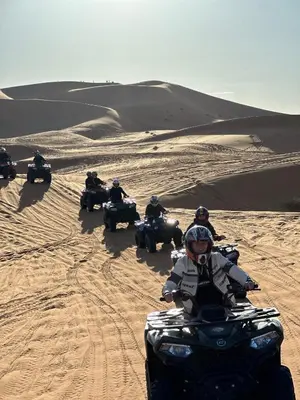 a group of people riding atvs in the desert at Sahara Desert Activites in Merzouga
