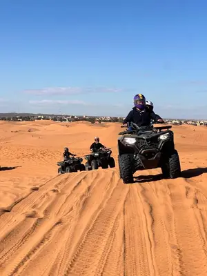 a group of people riding atvs in the desert at Sahara Desert Activites in Merzouga
