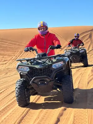 two people riding on atvs in the desert at Sahara Desert Activites in Merzouga
