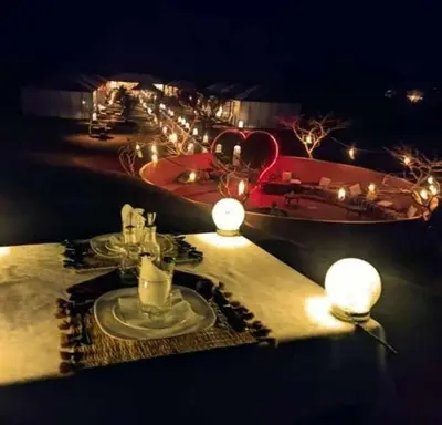 a table with a plate of food and a boat at jumeirah resort luxury desert camp in Merzouga