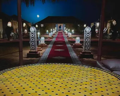 a stage with a red carpet and lights in a building at jumeirah resort luxury desert camp in Merzouga