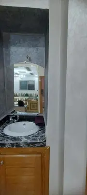 a bathroom with a sink and a mirror at Superbe appartement de luxe in Fès