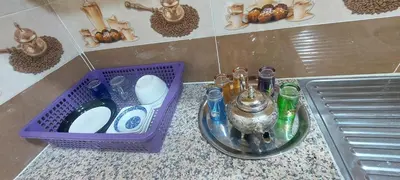 a purple basket sitting on a counter next to a sink at Superbe appartement de luxe in Fès