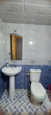 a bathroom with a toilet and a sink at Superbe appartement de luxe in Fès
