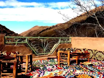 a pile of cloth on the ground in front of a mountain at Gite entre les deux vallées in Tacheddirt