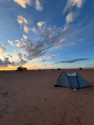 a blue tent sitting in the middle of a beach at Across Sahara in Bou Nou