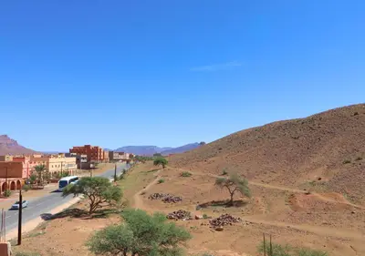 a view of a road in a desert with a hill at Drâa Oasis House Palm Apartment in Ourhiz