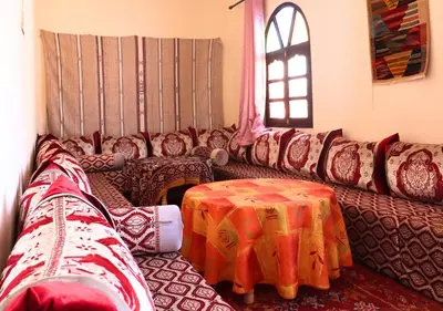 a living room with a couch and a table at Drâa Oasis House Palm Apartment in Ourhiz