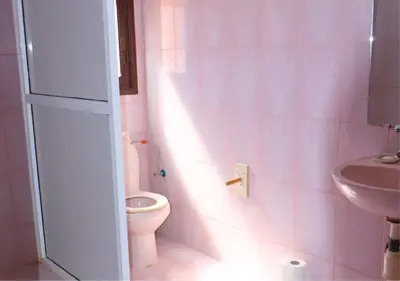 a pink bathroom with a toilet and a sink at Drâa Oasis House Palm Apartment in Ourhiz