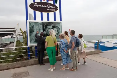 a group of people standing on a pier looking at a sign at Marokkoreizen in Fès