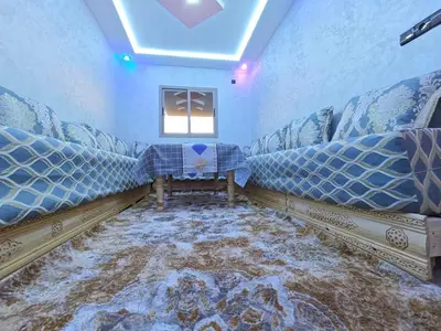 a room with two couches and a dirty floor at Dar Ines in Midelt