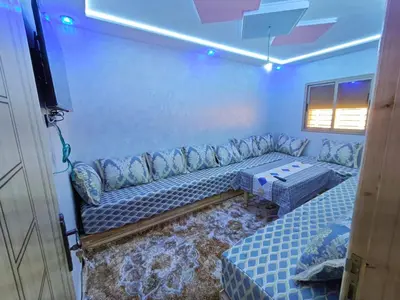 a living room with a couch and a table at Dar Ines in Midelt