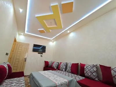 a living room with a couch and a tv at Dar Ines in Midelt