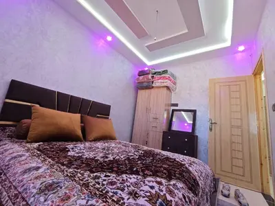 a bedroom with a large bed and a tv at Dar Ines in Midelt