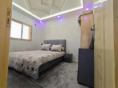 a bedroom with a bed and a television in it at Dar Ines in Midelt