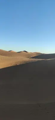 a sand dune in the middle of a desert at auberge lac iriki in Foum Zguid