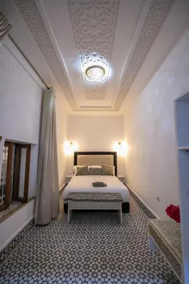 a bedroom with a bed and a coffered ceiling at Dar Mima in Fès