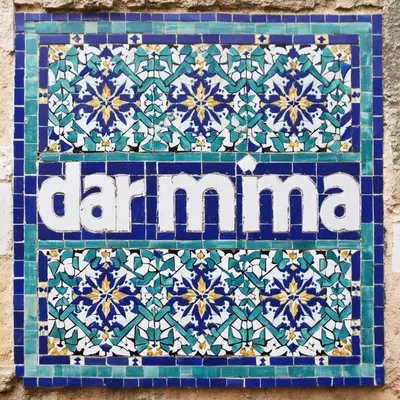 a tile with the word clamana on a wall at Dar Mima in Fès