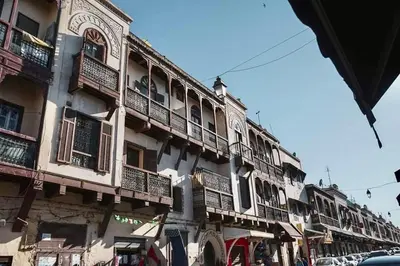 a building with balconies on the side of a street at Dar Mima in Fès