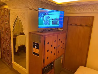 a tv sitting on top of a wooden cabinet at Entire place Medina's Home in Fès