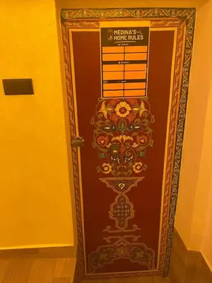 a brown door with a sign on it at Entire place Medina's Home in Fès