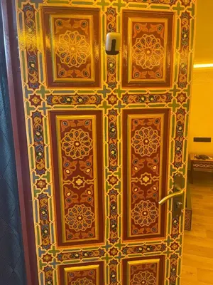 a wooden door with intricate designs on it at Entire place Medina's Home in Fès