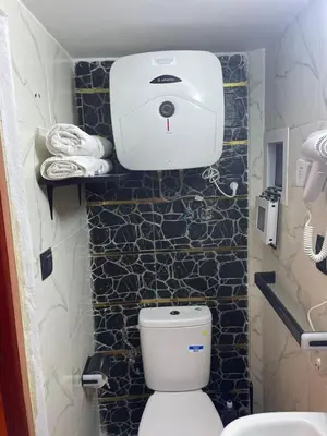 a small bathroom with a toilet and a sink at Entire place Medina's Home in Fès