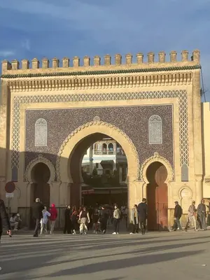 a group of people walking in front of a building at Entire place Medina's Home in Fès