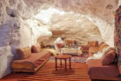 a room in a cave with a person standing in it at sahara camp in Oulad Akkou