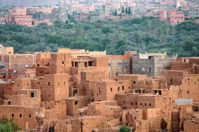 a bunch ofadobeadobe buildings in a city at sahara camp in Oulad Akkou