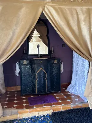 a altar in a room with a curtain and a window at Finest Luxury Camp in Merzouga