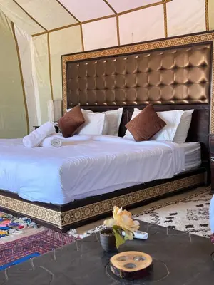 a bedroom with a large bed in a tent at Finest Luxury Camp in Merzouga