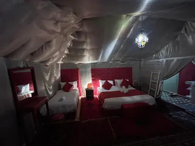 a bedroom with two beds in a tent at Finest Luxury Camp in Merzouga