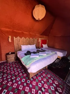 a bedroom with two beds in a room at Finest Luxury Camp in Merzouga