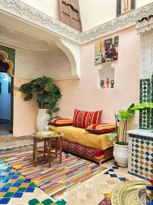 a living room with a couch and a table at Riad Mounadim Fes -Authentic Riad Luxury Fes in Fès