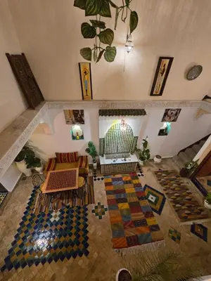 an aerial view of a living room with a couch at Riad Mounadim Fes -Authentic Riad Luxury Fes in Fès
