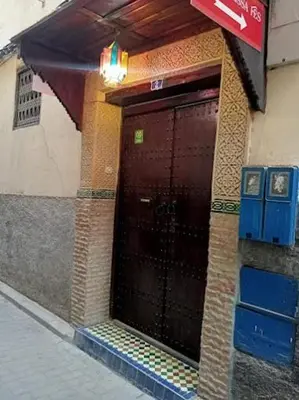 a entrance to a building with a brown door at Riad Mounadim Fes -Authentic Riad Luxury Fes in Fès