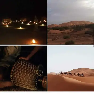 a group of people walking in the desert at night at jumeirah standard camp merzoug in Merzouga