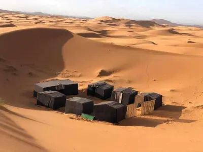 a group of blocks in the sand in the desert at jumeirah standard camp merzoug in Merzouga