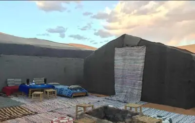 a room with a tent in the desert at jumeirah standard camp merzoug in Merzouga